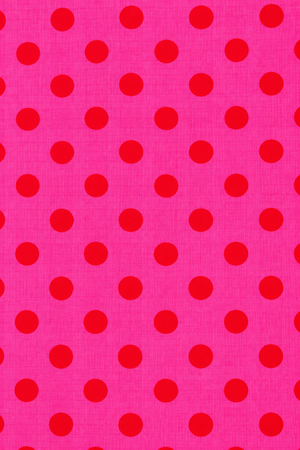 Bright pink fabric with red dots for dressmaking
