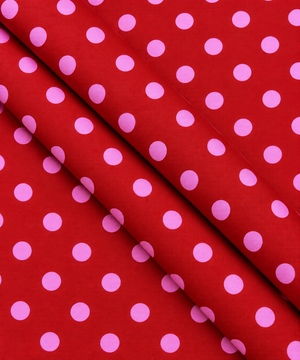 Red fabric with evenly spaced pink dots