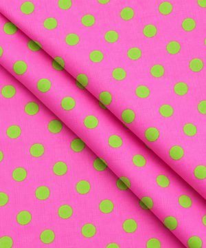 Pink fabric with evenly spaced green dots