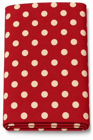 Folded maroon fabric with cream polka dots displayed on a green textured background
