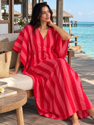 Striped cotton kaftan dress styled with a woven beach tote