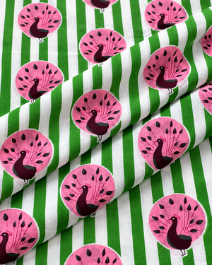 Decorative peacock cotton fabric with pink birds on a green striped background.