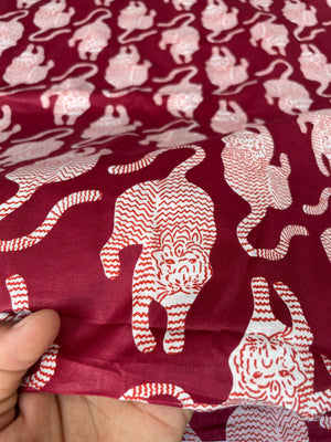 White tiger print on deep red cotton fabric