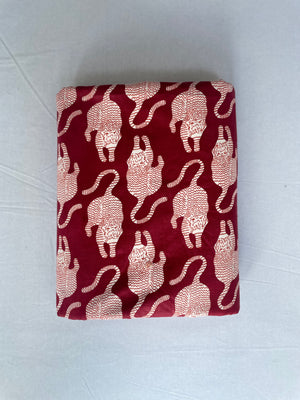 White tiger motif cotton fabric on red background