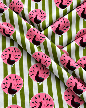 Light green and white striped fabric with repeating pink peacock motifs.