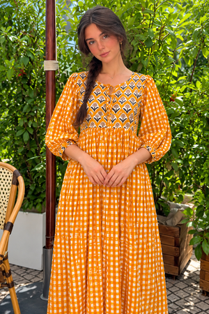 Flowy orange and white checked dress with feminine puff sleeves