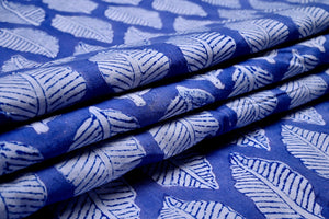 White leaf print on blue cotton fabric