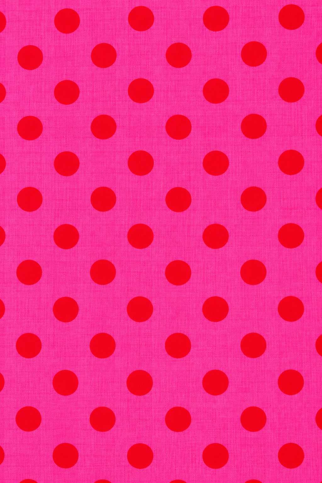 Bright pink fabric with red dots for dressmaking