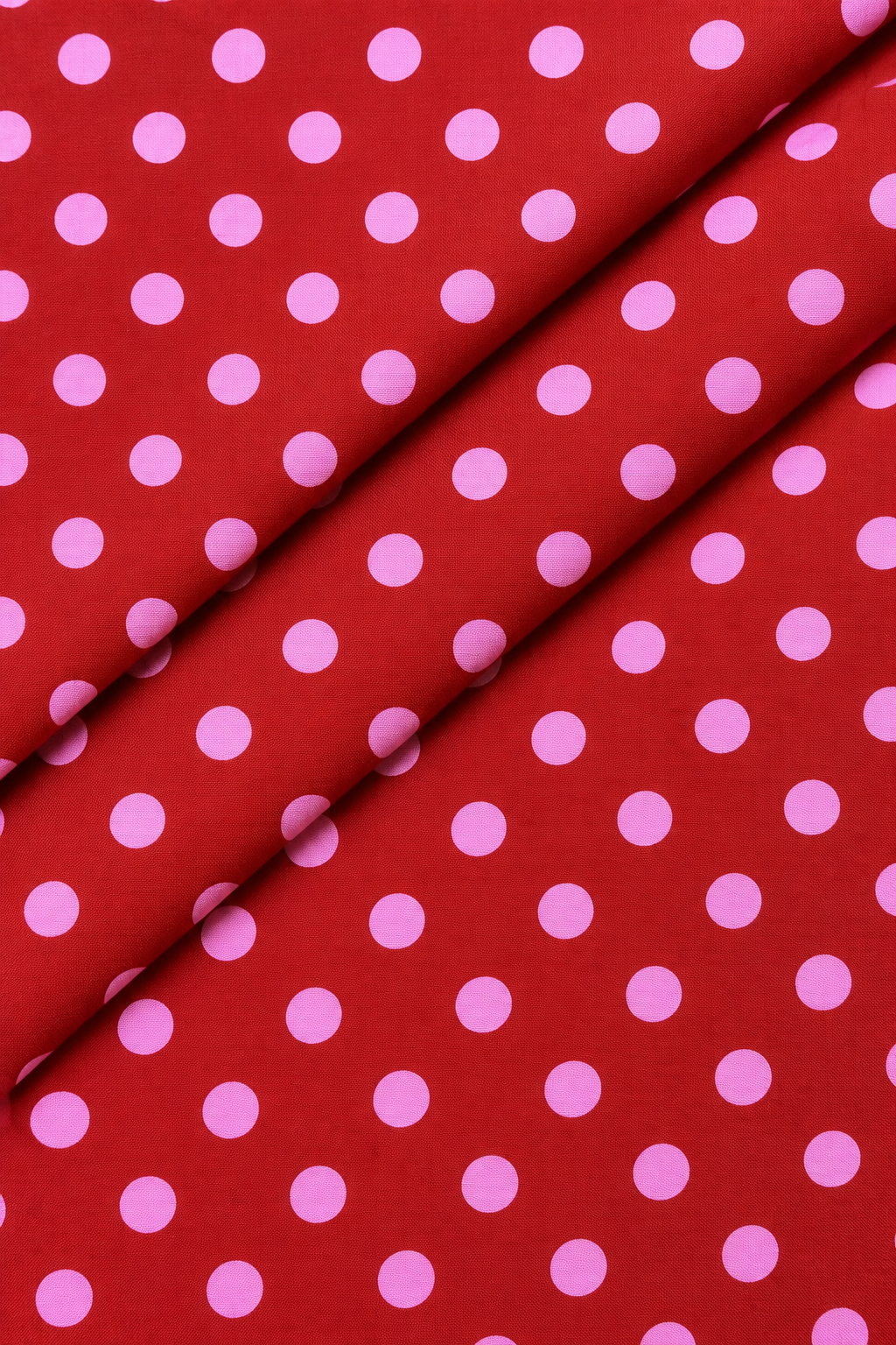 Red and pink polka dot fabric close up texture