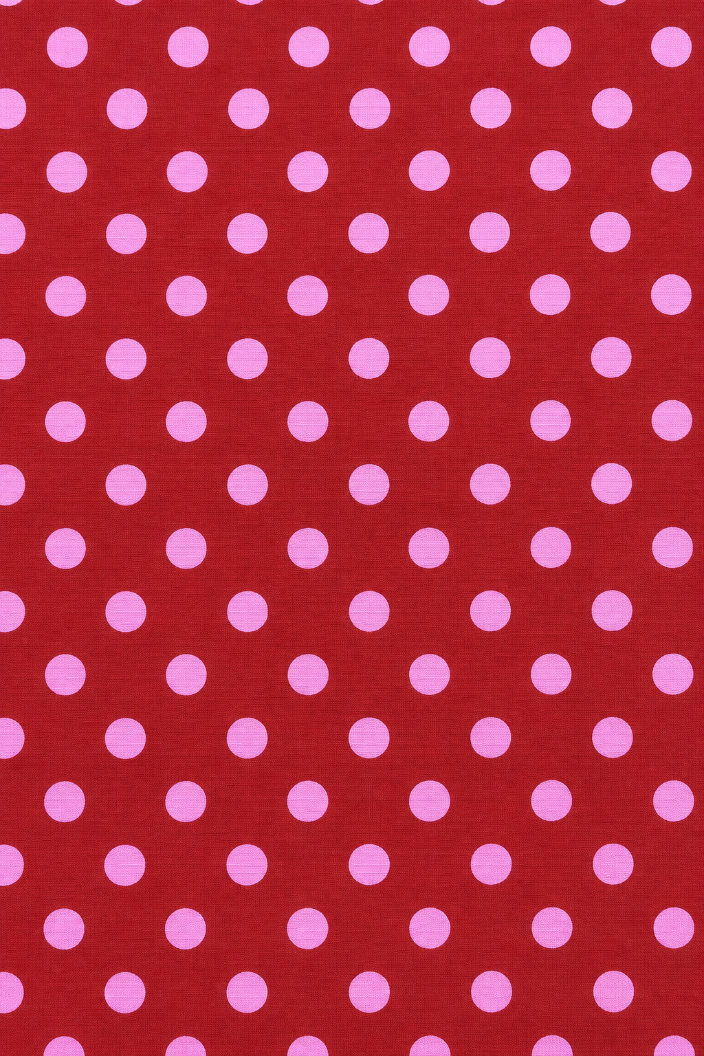 Pink polka dot pattern on red fabric