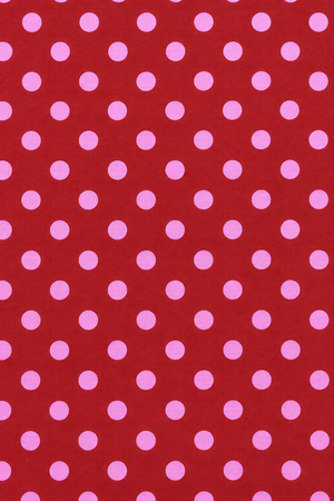 Pink polka dot pattern on red fabric
