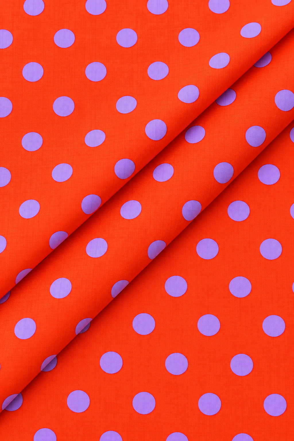 Purple polka dot pattern on bright orange fabric
