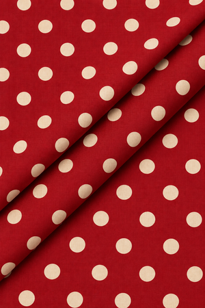 Maroon and cream polka dot fabric with a subtle woven textile texture