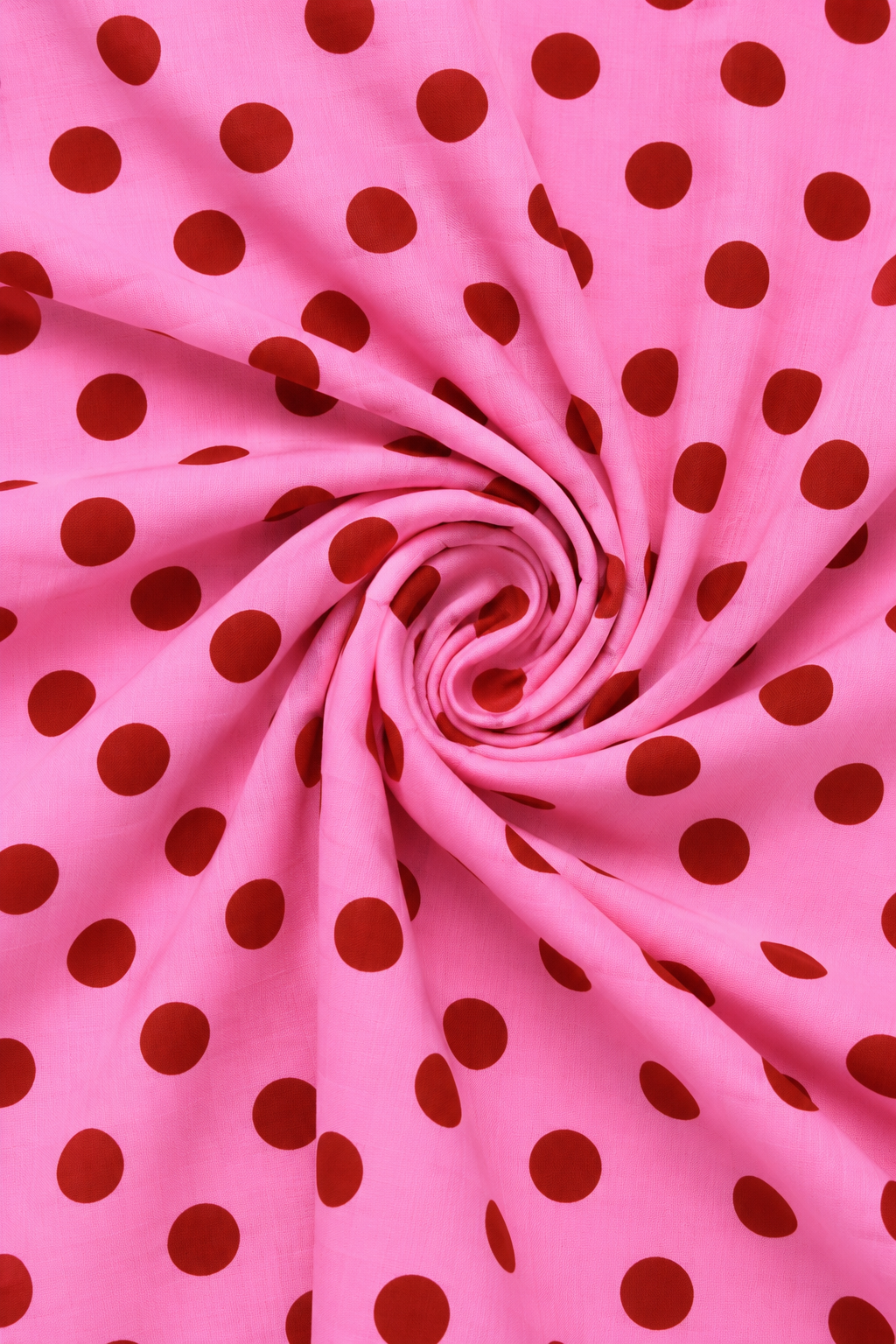 Close-up of pink polka dot printed fabric with visible textile texture