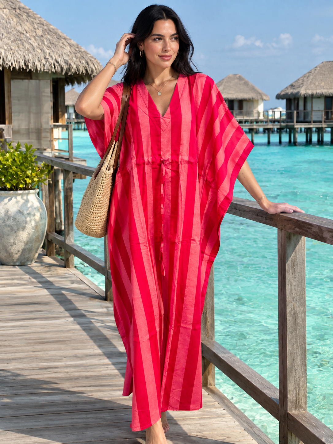 Pink resort wear kaftan dress overlooking turquoise tropical water