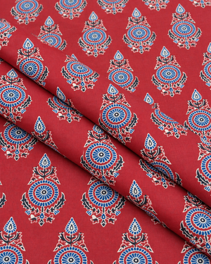 Red background fabric featuring traditional blue and white ornamental flowers