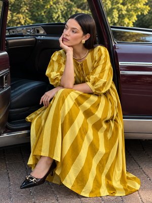 Full-length mustard yellow dress with three-quarter puff sleeves