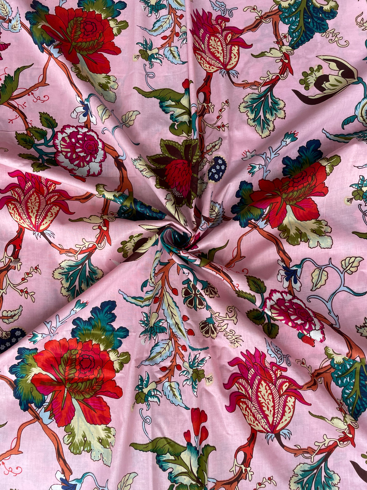 Colorful floral print cotton fabric on pink background