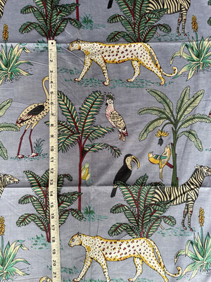 Jungle wildlife cotton fabric with tropical foliage
