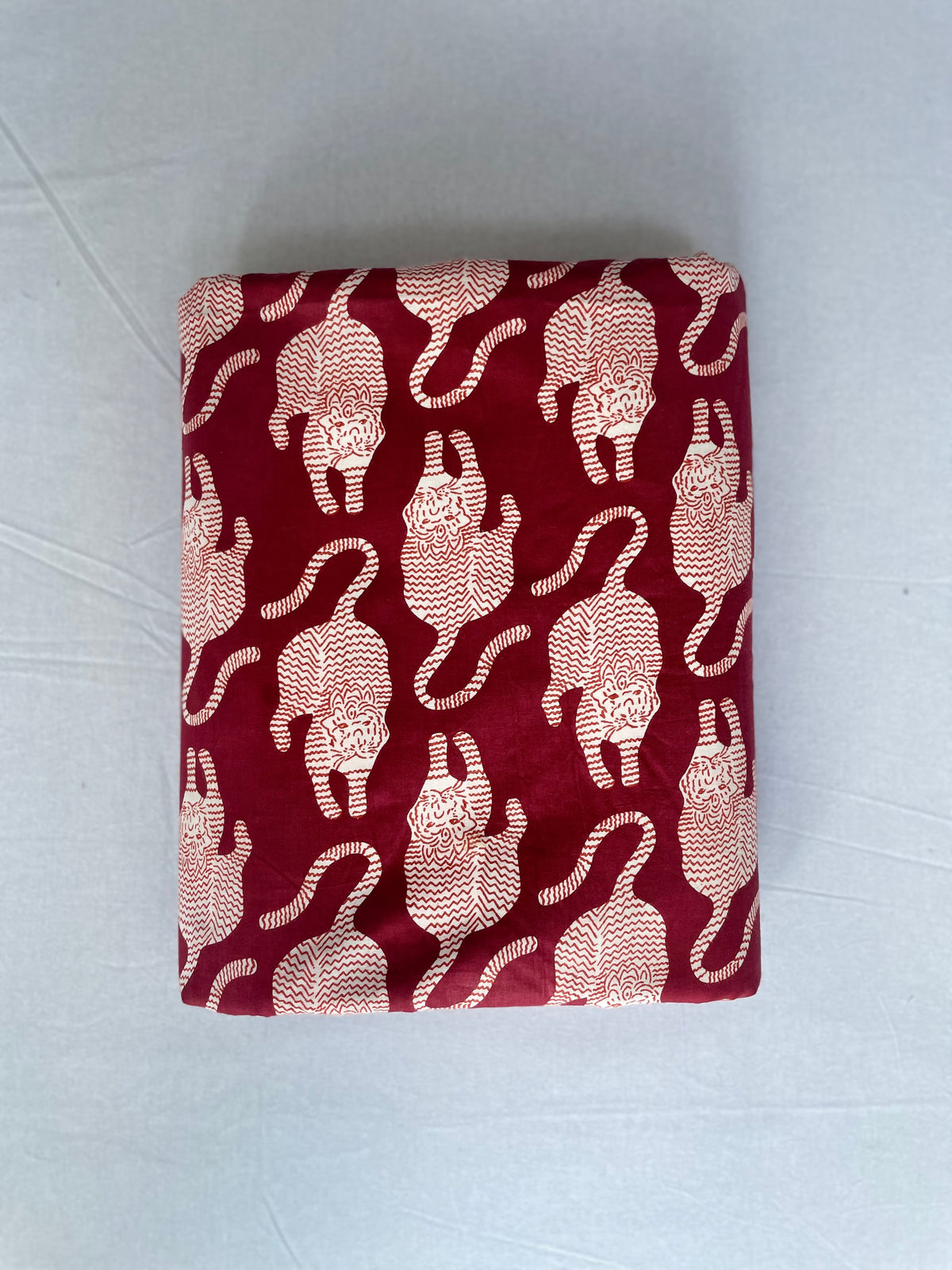 White tiger motif cotton fabric on red background