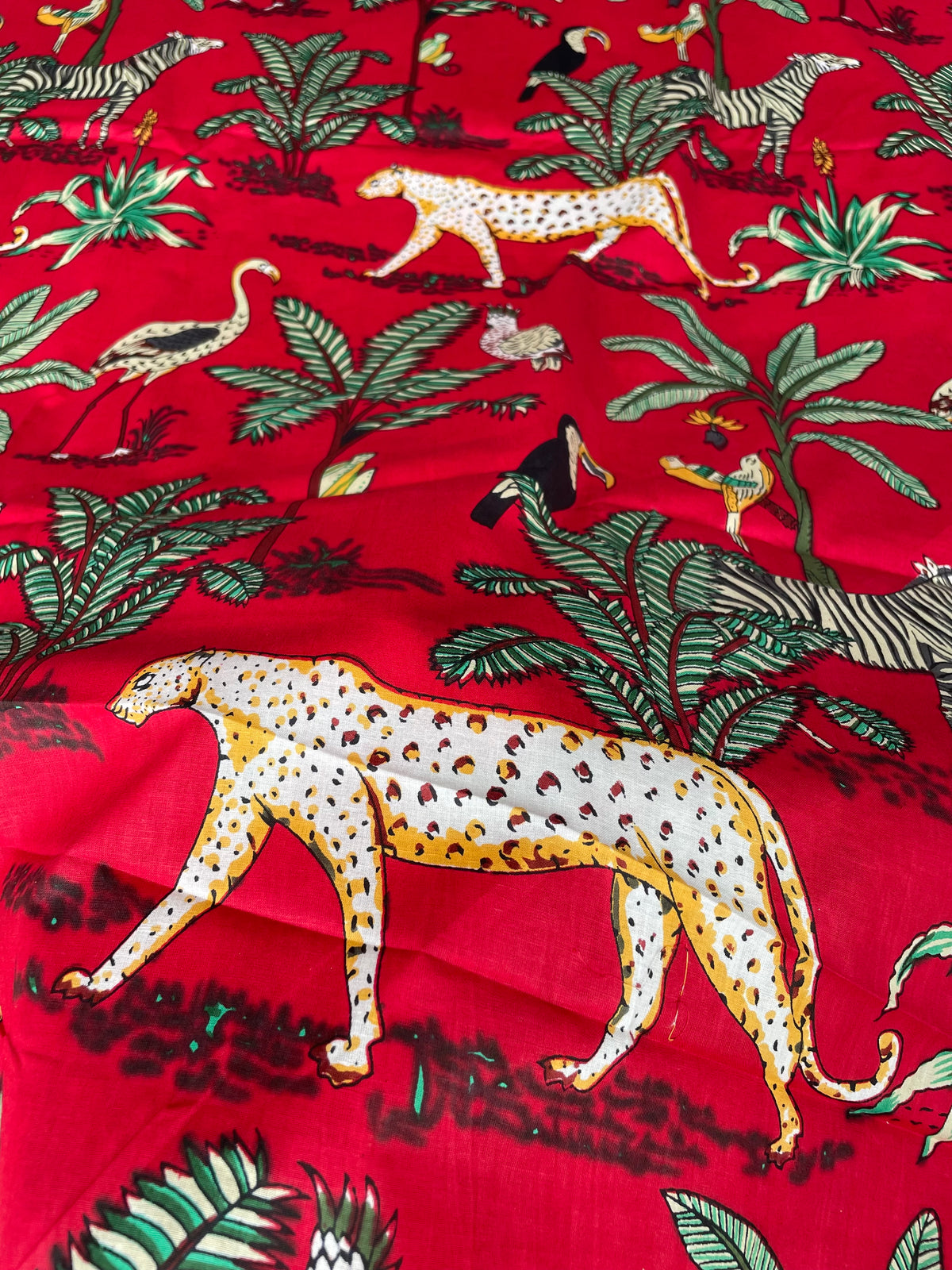 Red safari print fabric with jungle animals