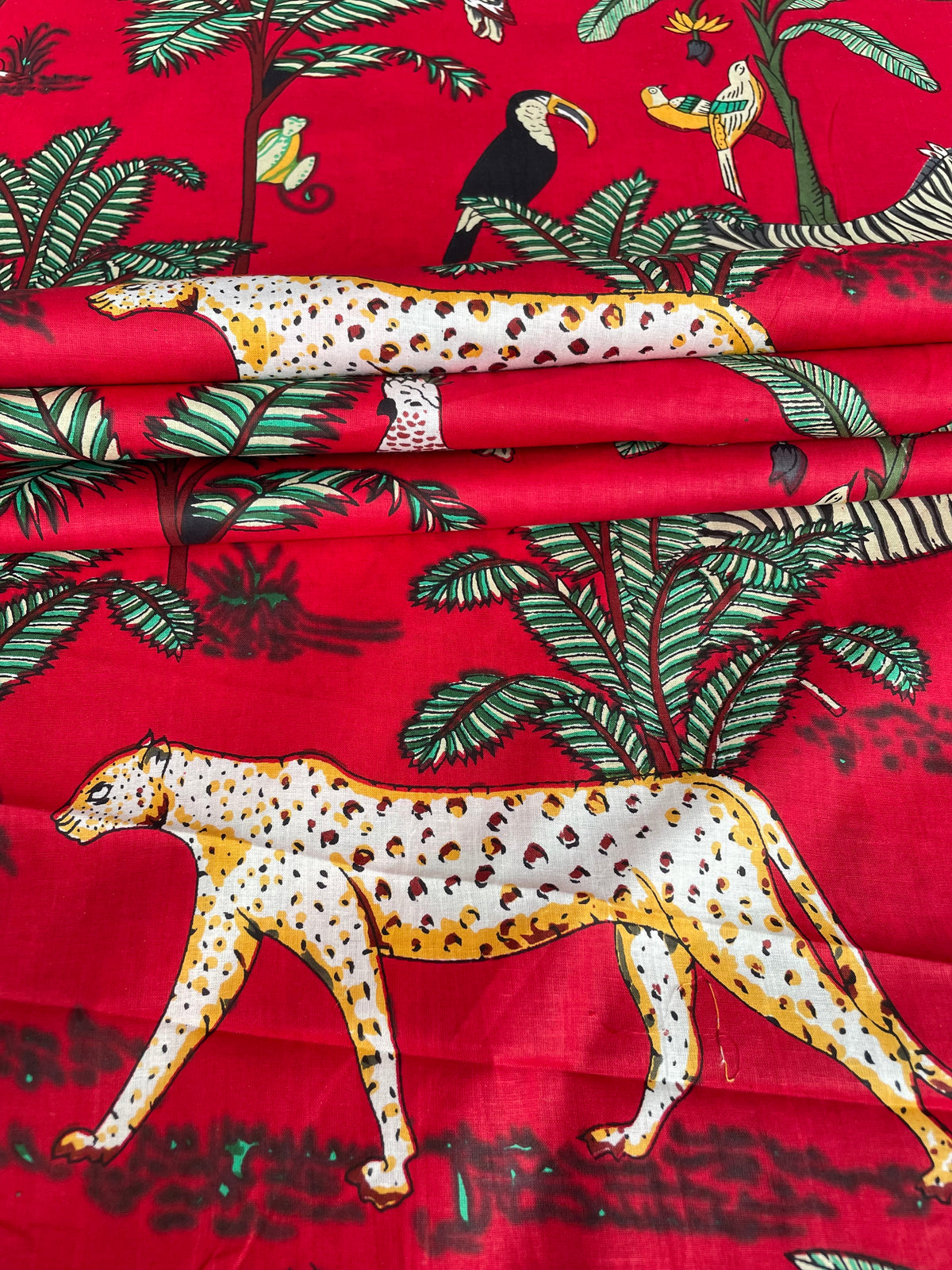 Jungle animal fabric with tropical birds and foliage
