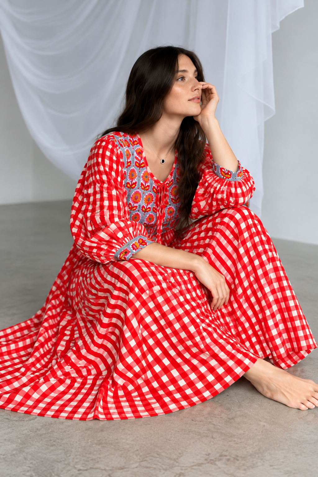 Women's red maxi dress with empire waist and flowing skirt