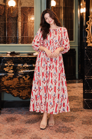 Women's long printed dress styled with neutral sandals