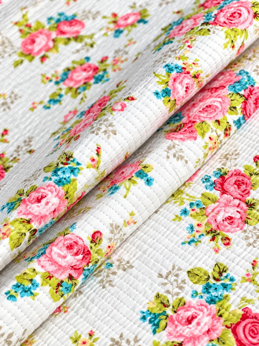Vintage-inspired rose print quilted fabric for sewing and craft projects.