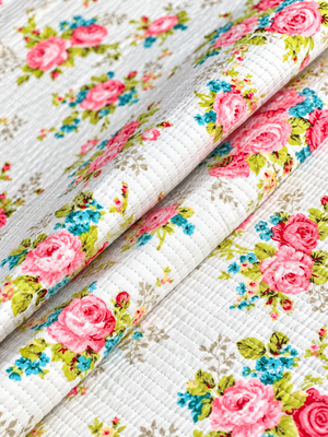 Vintage-inspired rose print quilted fabric for sewing and craft projects.