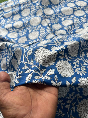 Blue fabric with white botanical flower pattern