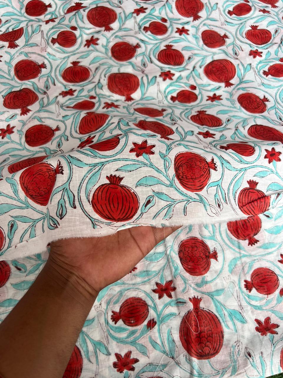 Red pomegranate and turquoise leaf block print fabric